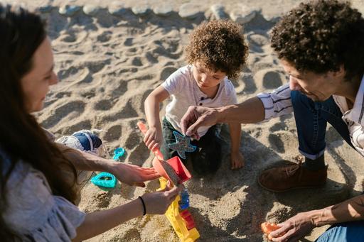 Parents playing with child on the beach