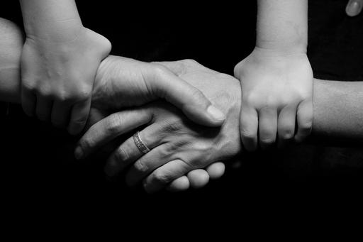 Child holding parents hands