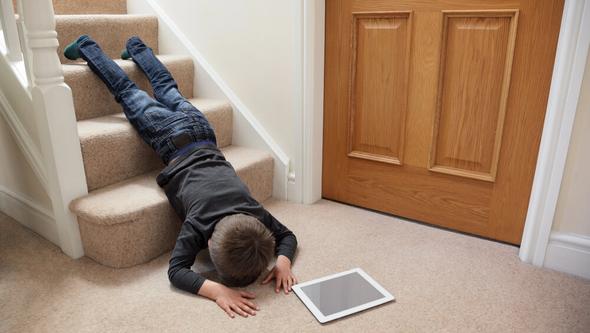 Young boy who has fallen down the stairs
