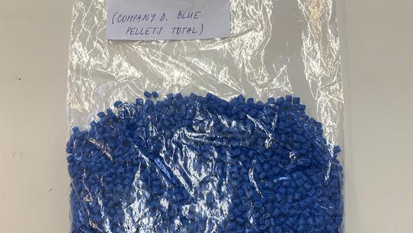 Picture of a bag with blue plastic pellets