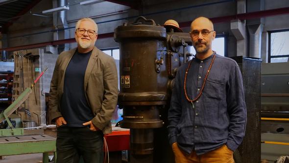 Two men in a metall workshop