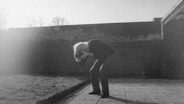 blank and white image of a man taking a picture