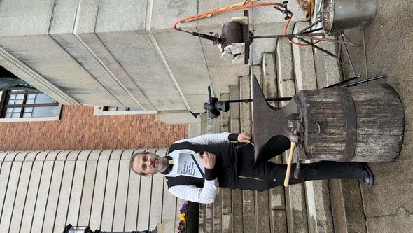 A man outside an old official building with a forging evil